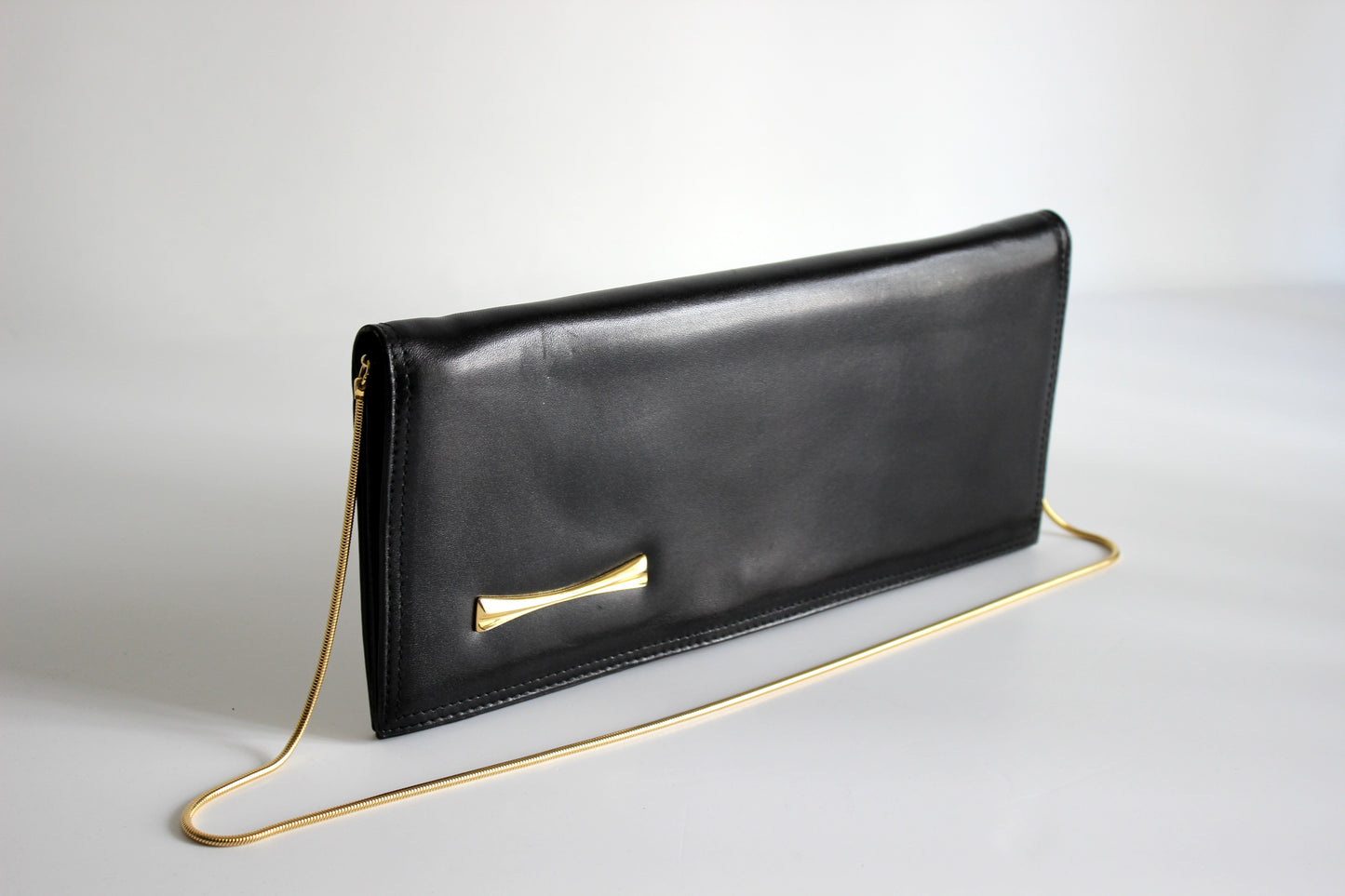 Eris – mid ’80s–early ’90s black calf-leather envelope clutch with gold-tone snake-chain strap