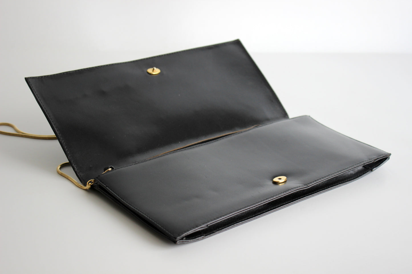 Eris – mid ’80s–early ’90s black calf-leather envelope clutch with gold-tone snake-chain strap
