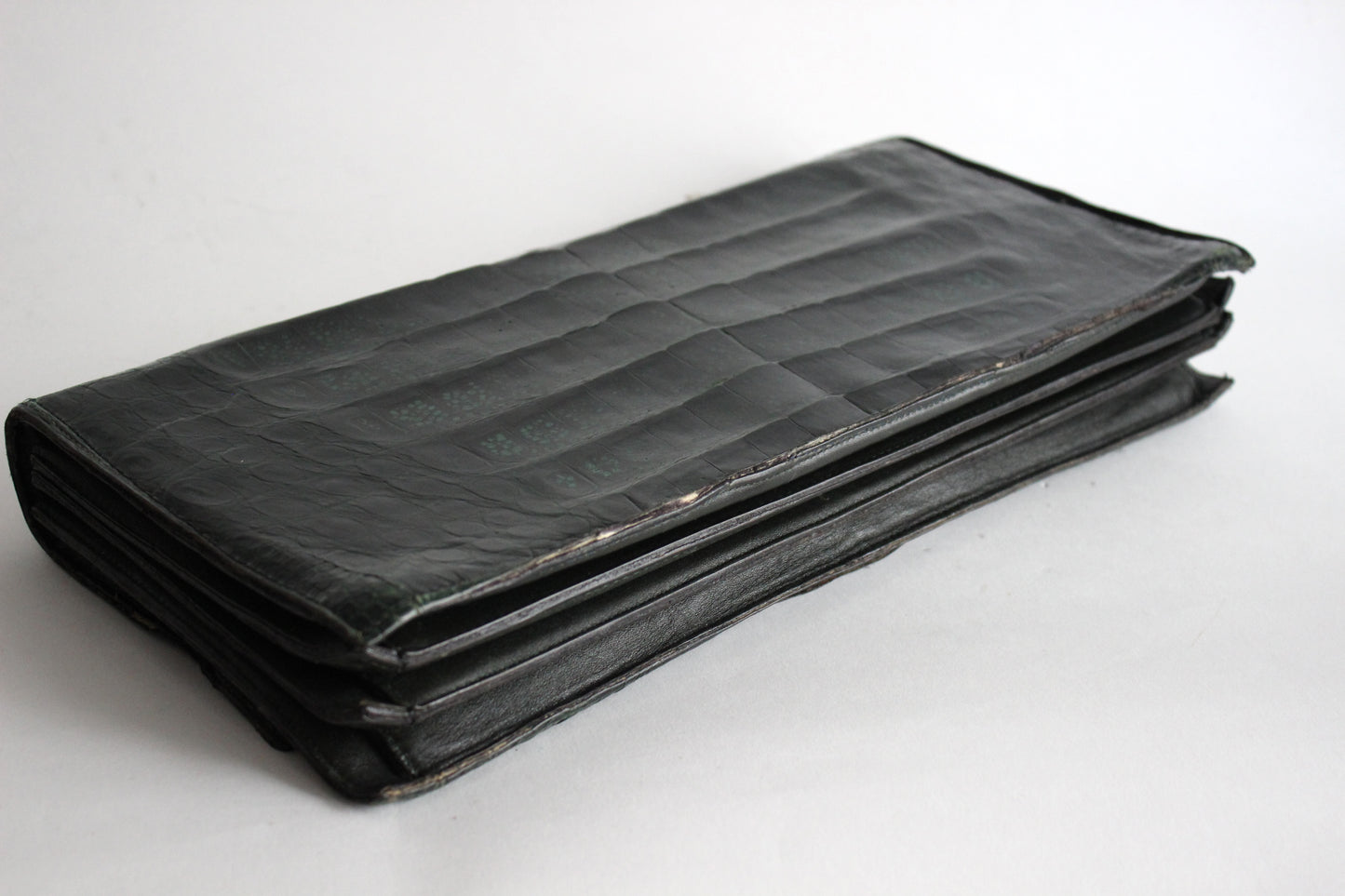 Persephone – early ’70s green-black crocodile-embossed leather clutch with silver-arc handle