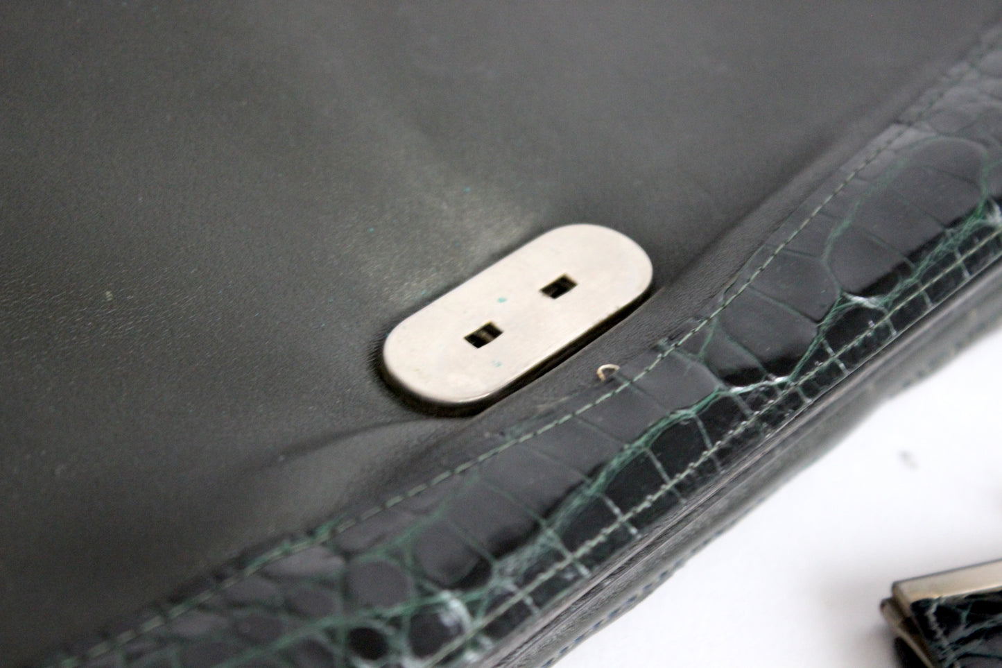 Persephone – early ’70s green-black crocodile-embossed leather clutch with silver-arc handle