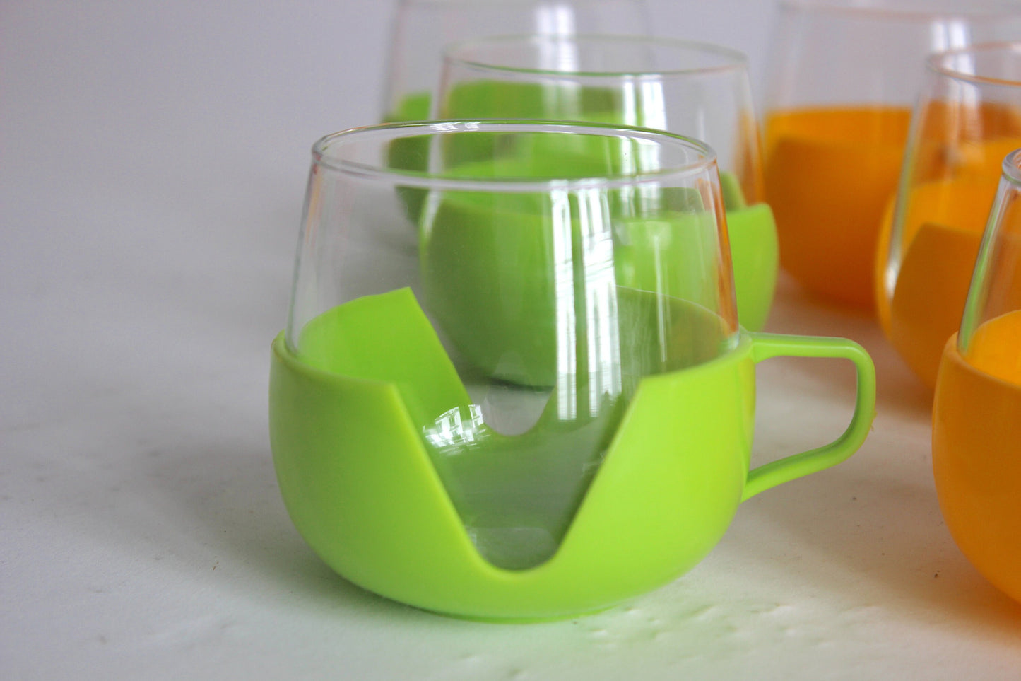 Set of 9 multicolored glass tumblers for tea or coffee with plastic handles - Holland 60s / 70s