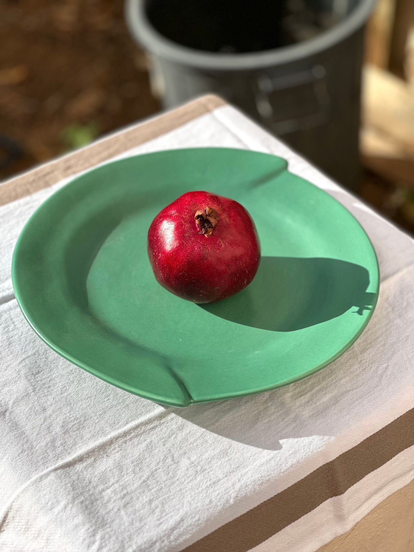 Julie Sanders “Cyclamen” dinnerware set – matte green ceramic, 20-piece, 1990s
