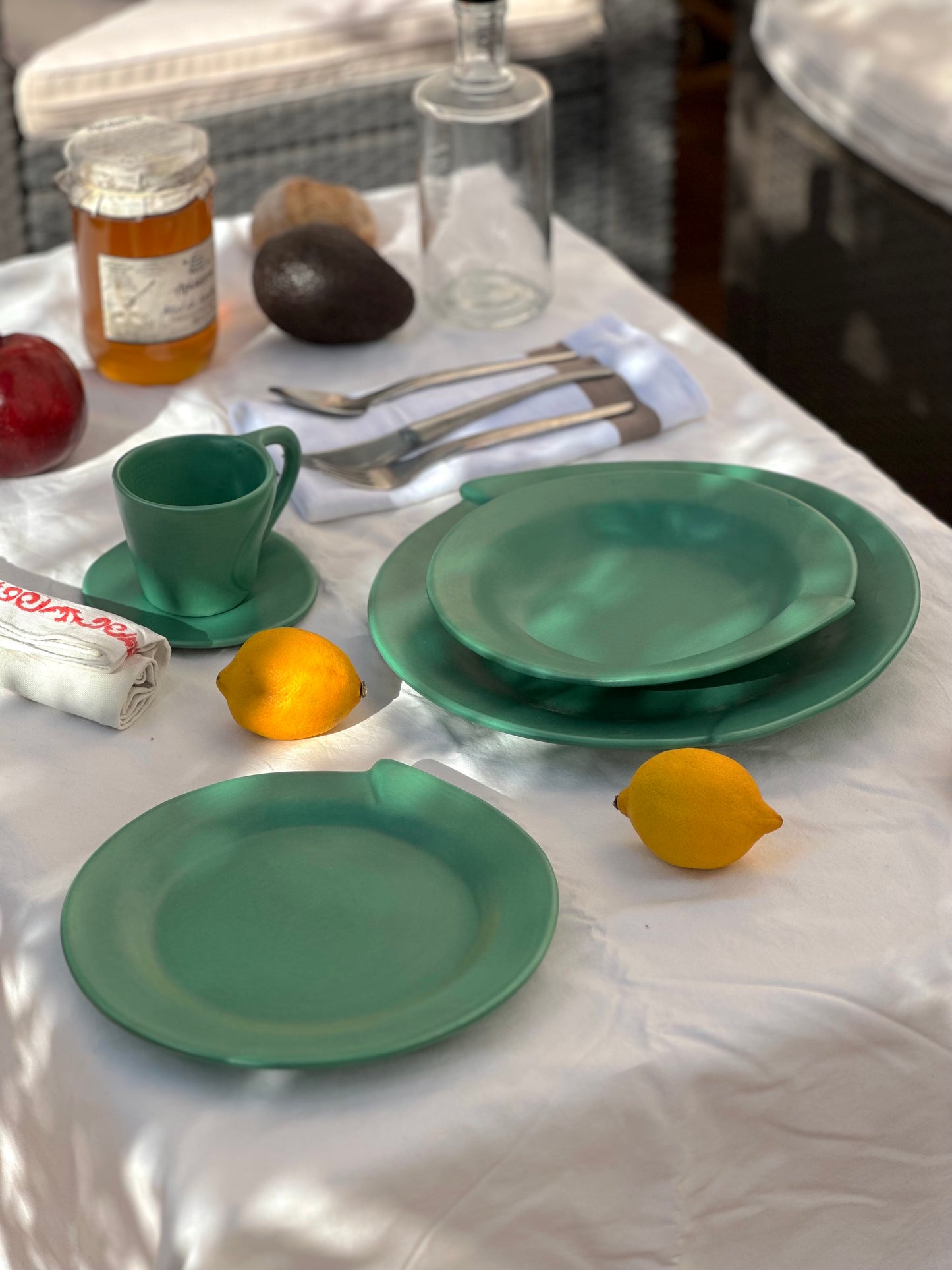 Julie Sanders “Cyclamen” dinnerware set – matte green ceramic, 20-piece, 1990s