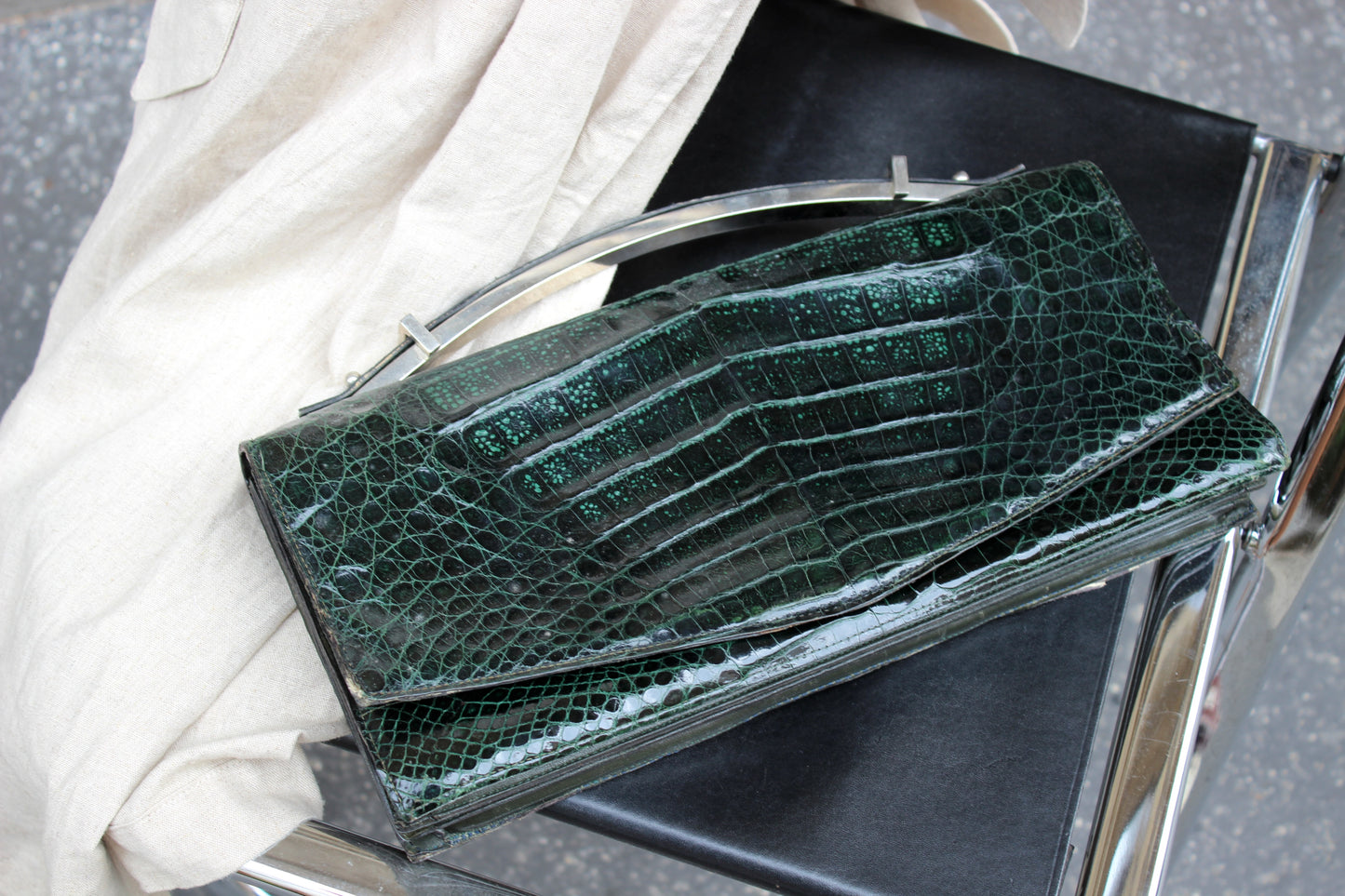 Persephone – early ’70s green-black crocodile-embossed leather clutch with silver-arc handle