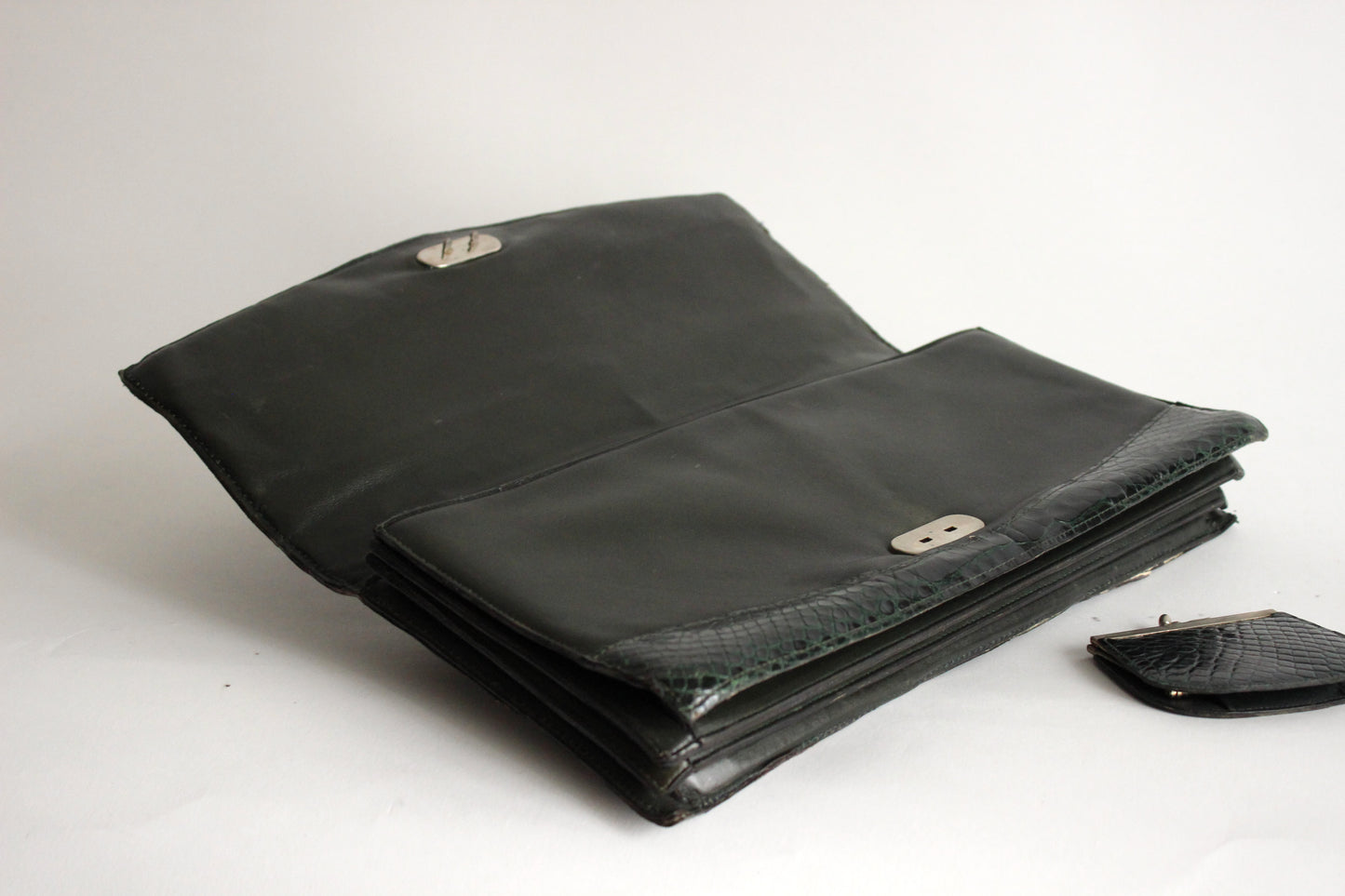 Persephone – early ’70s green-black crocodile-embossed leather clutch with silver-arc handle
