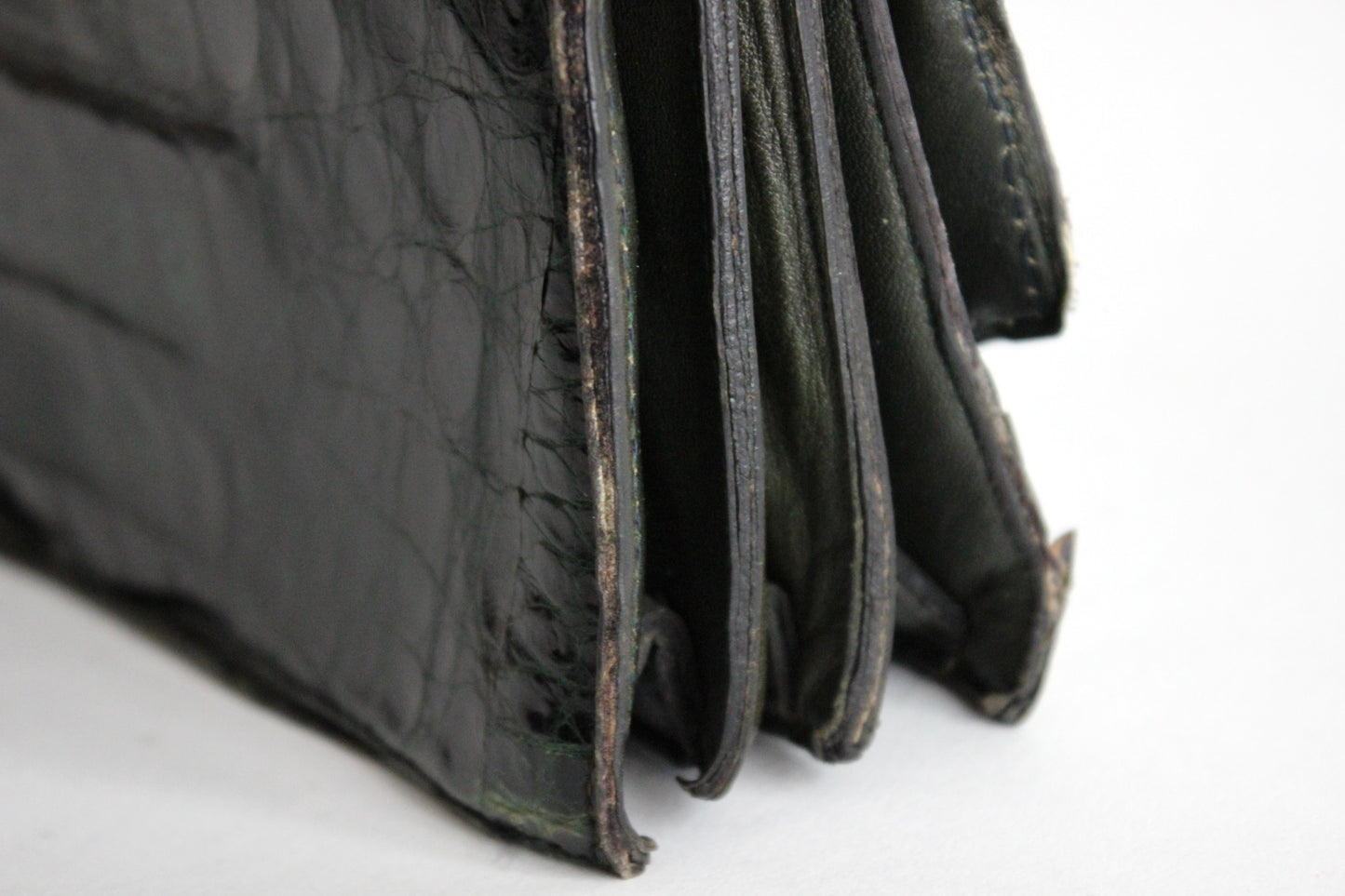 Persephone – early ’70s green-black crocodile-embossed leather clutch with silver-arc handle