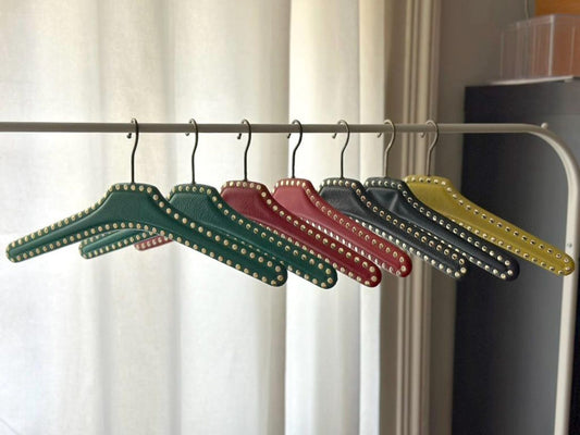 Set of 7 vintage skai hangers with studs. Mid-century. Germany, 1960s